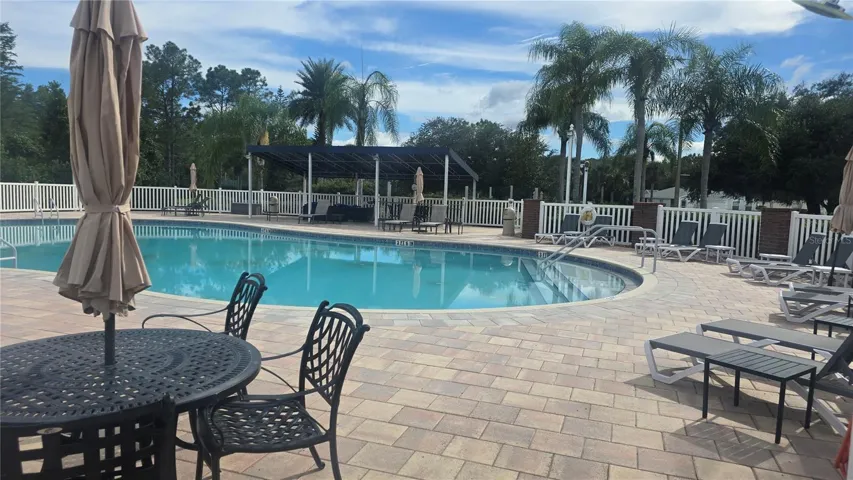 Dining or sunbathing by the pool, hot tub and community grill