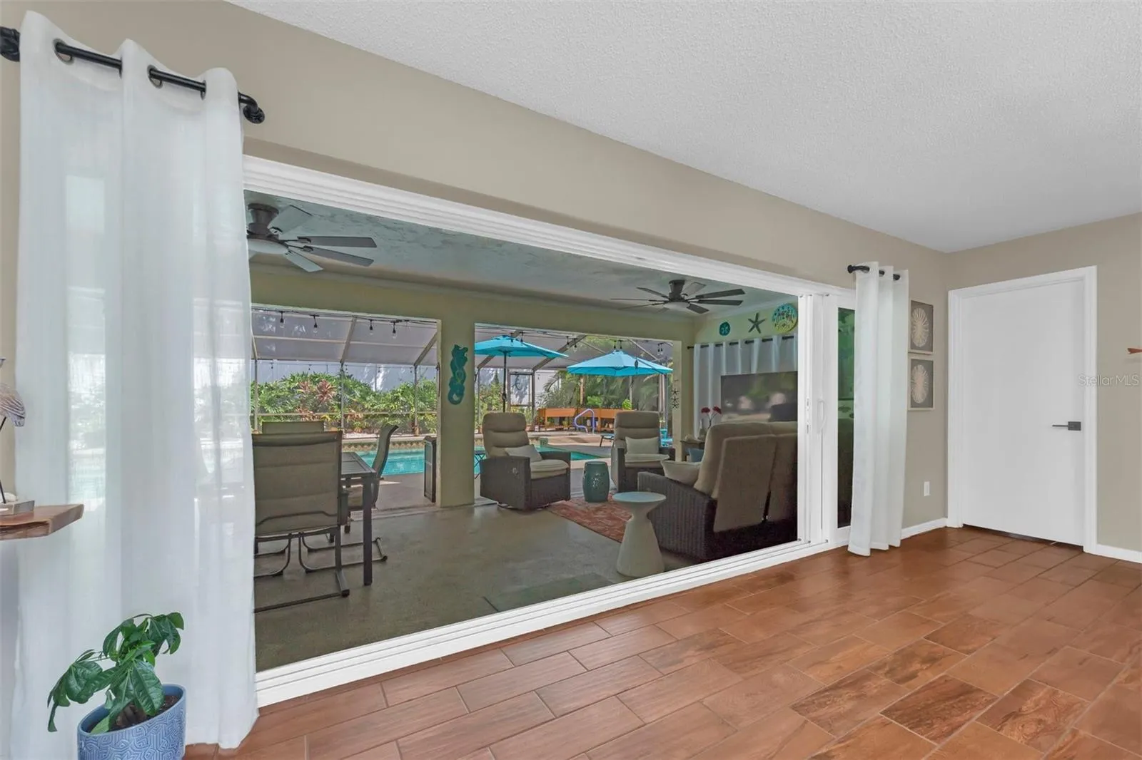 IMPACT POCKET DOORS OPEN TO SCREENED LANAI