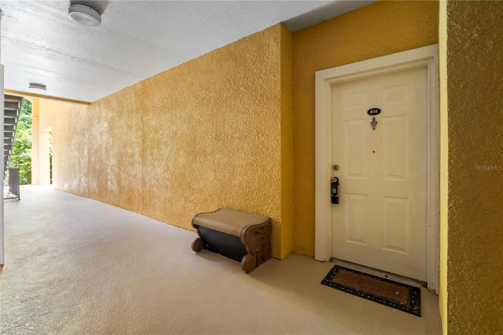 Covered front door, with a storage bench beside it