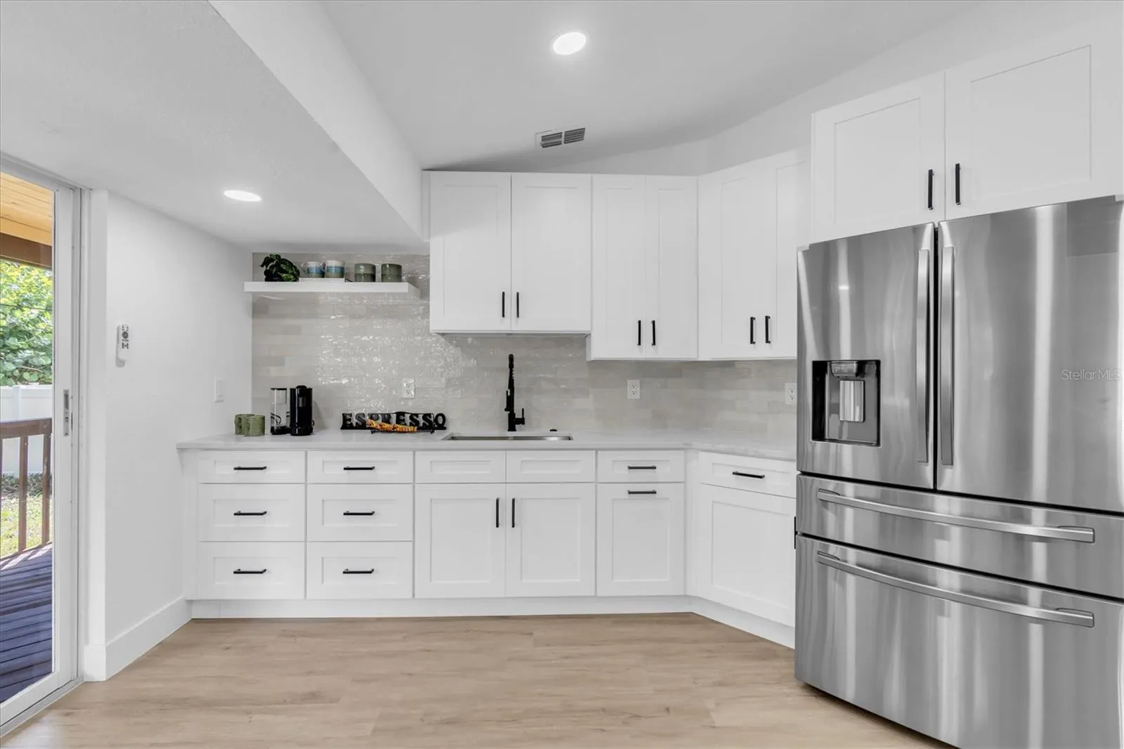 Two generous sinks—including a dedicated prep sink—plus two pantries provide outstanding functionality.