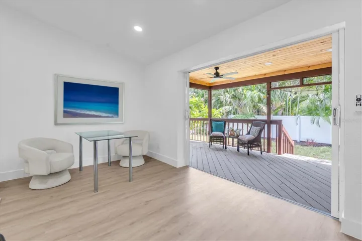 Four sets of sliding glass doors connect the home to the tropical backyard and covered lanai.