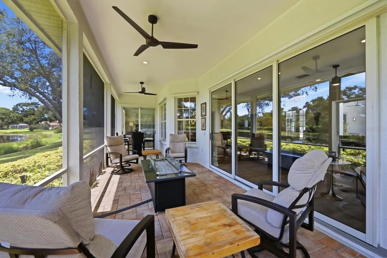The screened back patio features a gas fire table plumbed to a 250 gallon buried propane tank