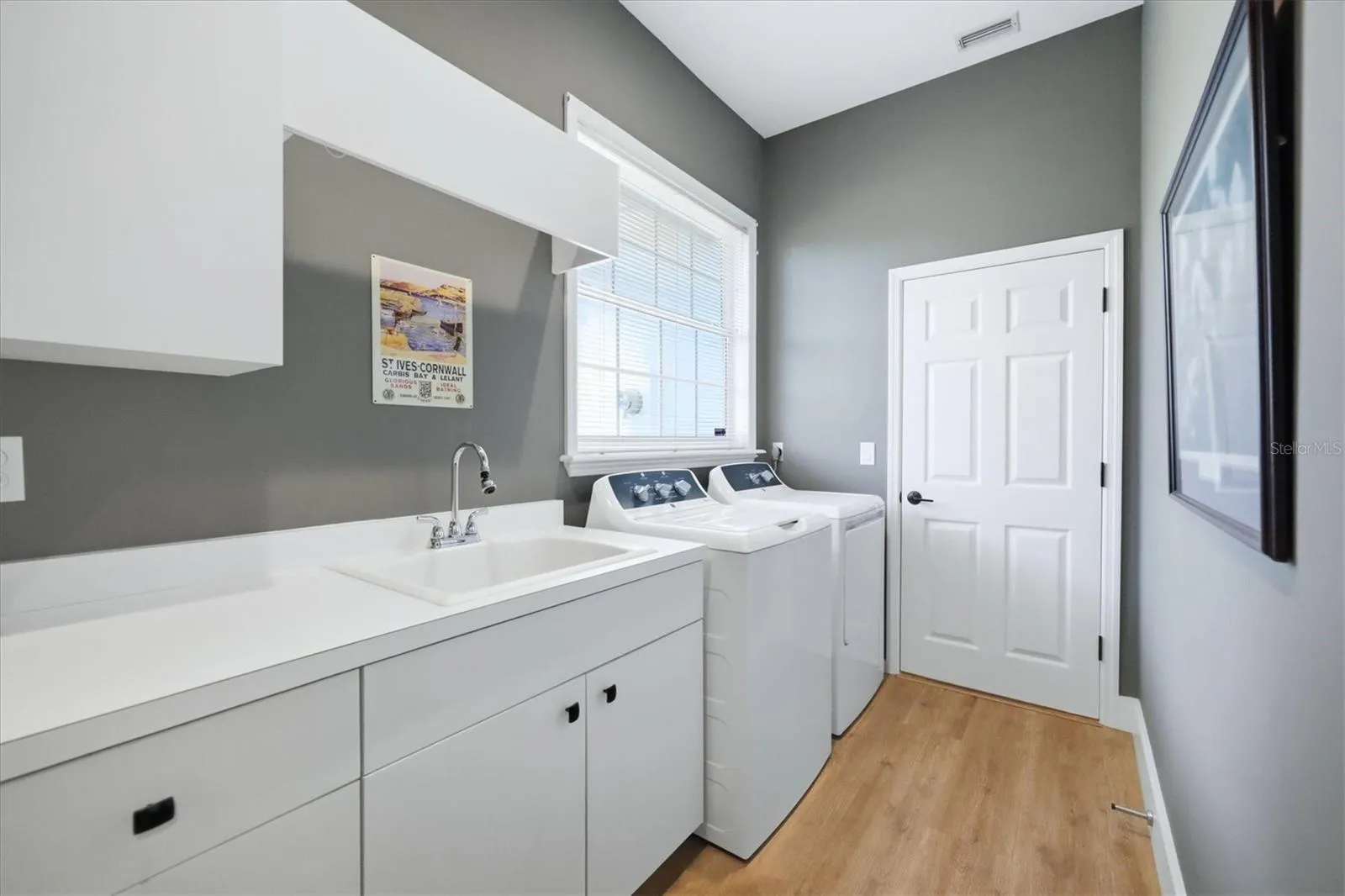 Your Laundry Room features a commercial grade GE washer/dryer, tons of storage and an upgraded utility sink.