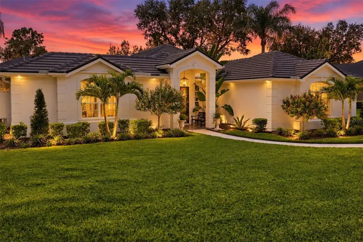 Updated lighting & Landscaping welcome you to 8708 Woodbriar Drive