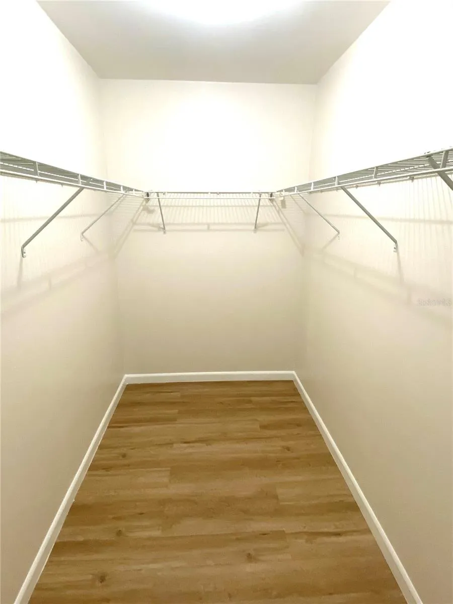 Primary bedroom walk in closet