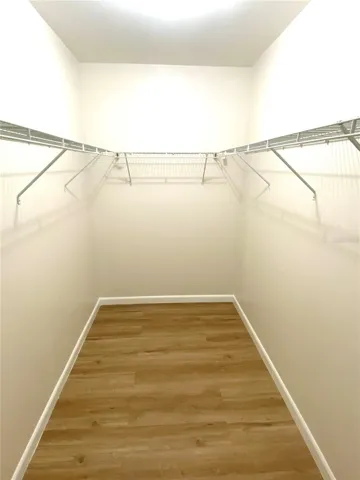 Primary bedroom walk in closet