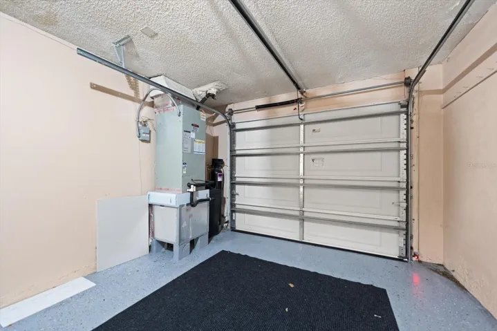Garage with garage door opener, repainted flooring, water softener, etc.