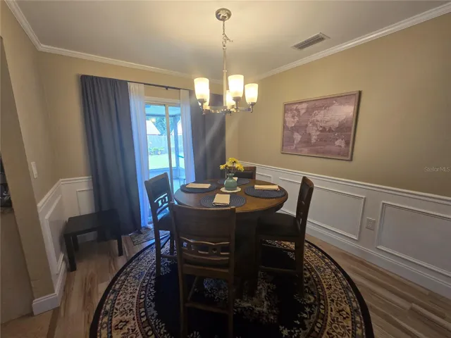 DINING AREA COMPLETE WITH CHAIR RAIL AND CROWN MOLDING