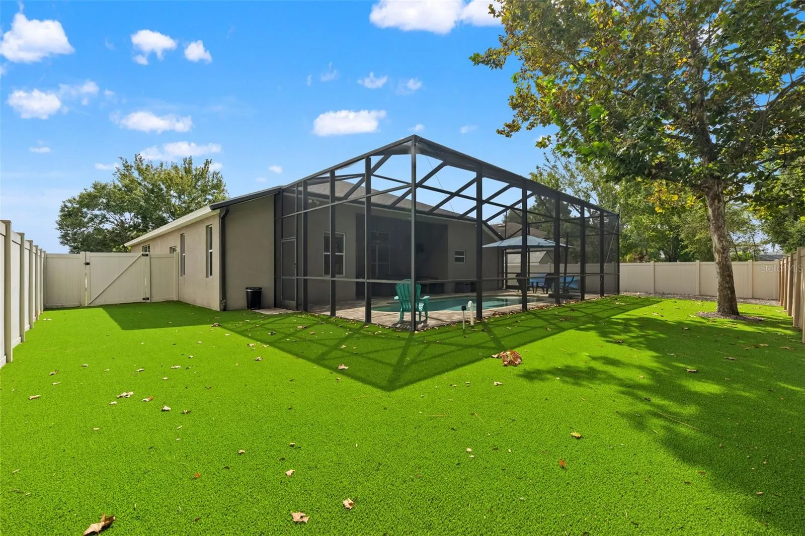 The fenced backyard extends beyond the pool enclosure, giving you additional outdoor space without rear neighbors directly behind you.