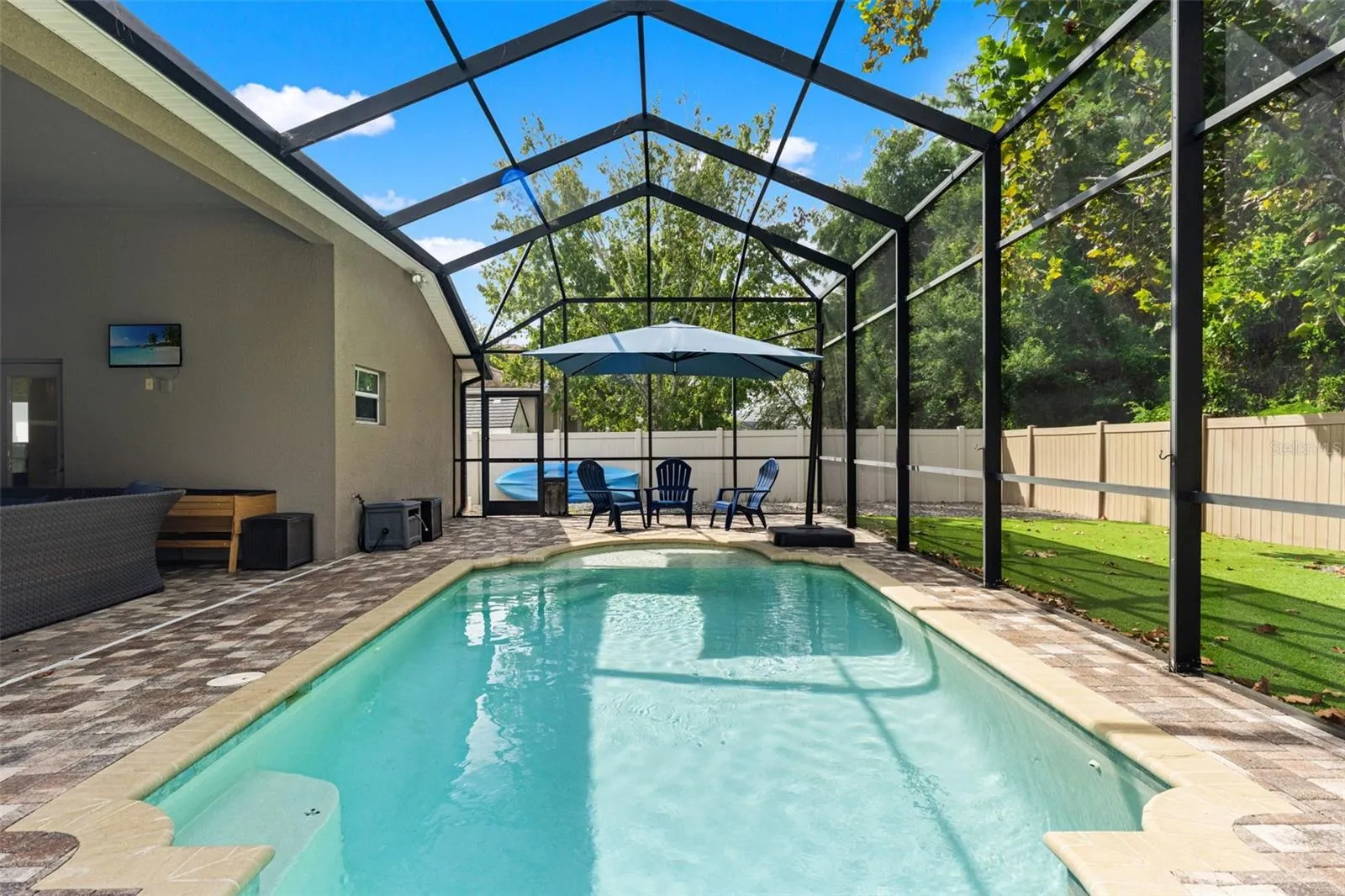 The full screen enclosure lets you enjoy the saltwater pool while still feeling connected to the surrounding outdoor space.