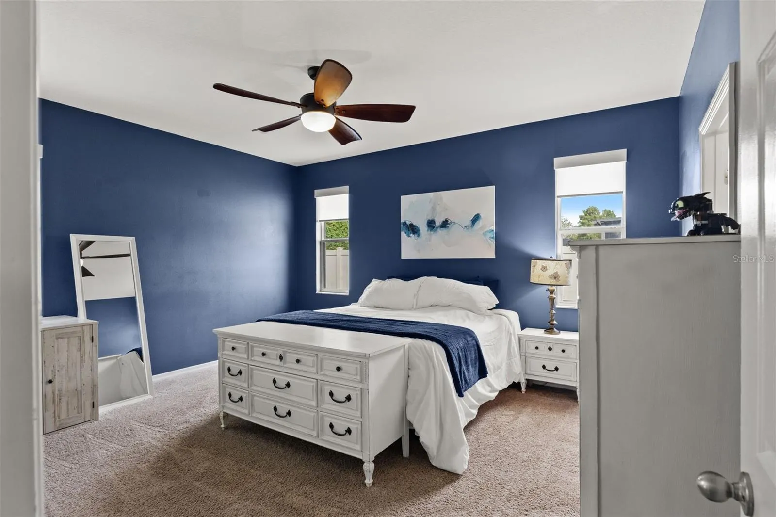 The spacious primary suite offers plenty of room for substantial furniture while maintaining a comfortable, uncluttered feel.