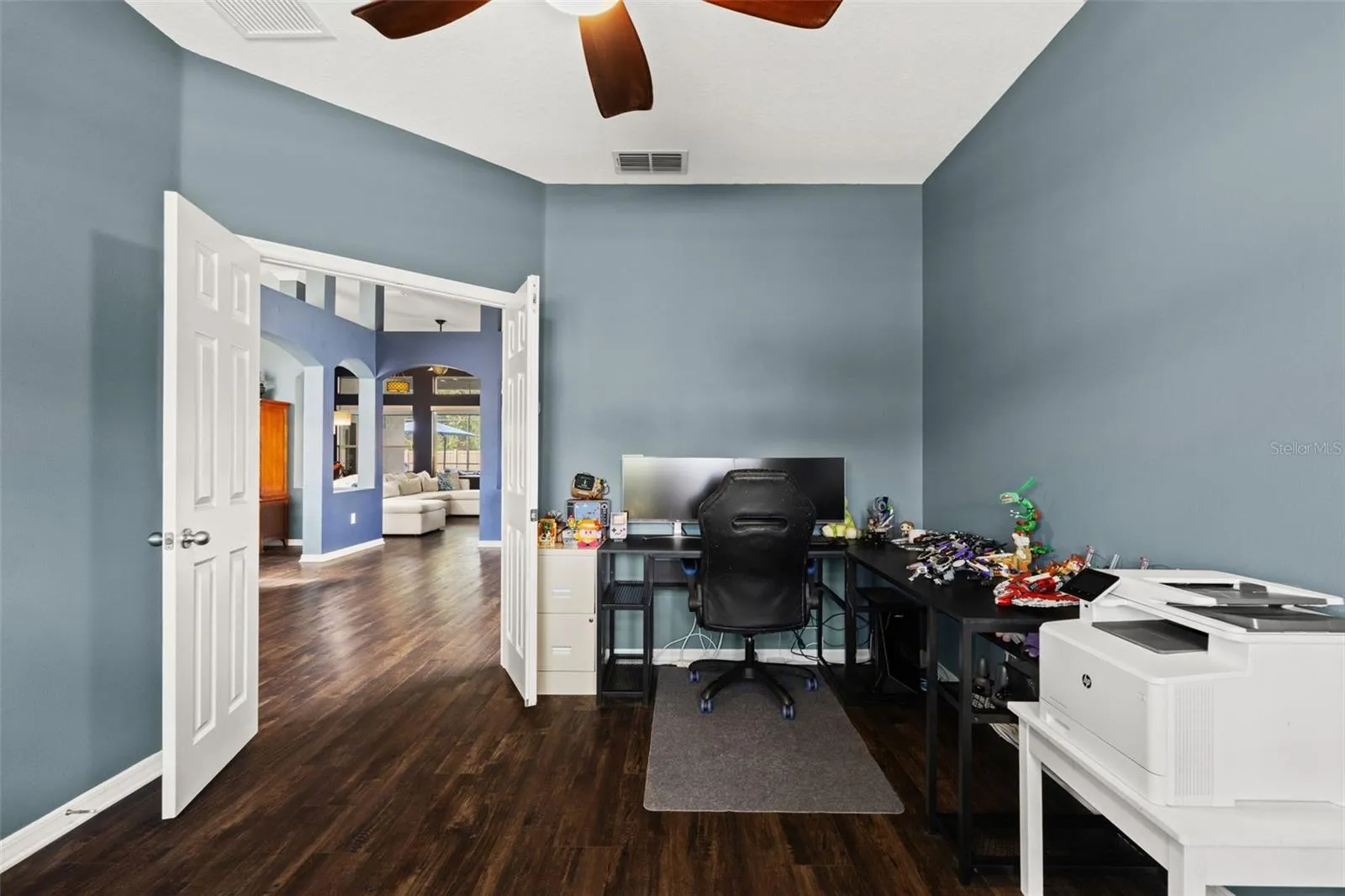 French doors allow the den to be closed off when needed—ideal for an office, study, hobby room, or quiet retreat.
