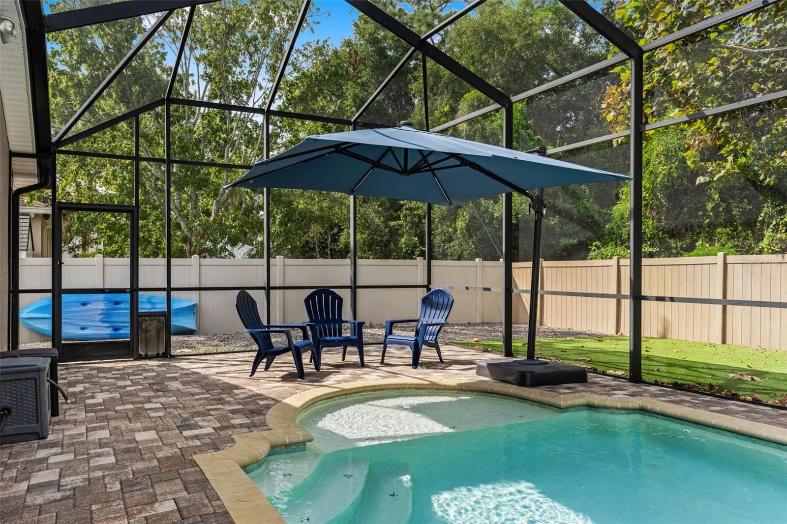 Sun or shade? There’s room for both, with open poolside space complemented by a large umbrella-covered seating area.