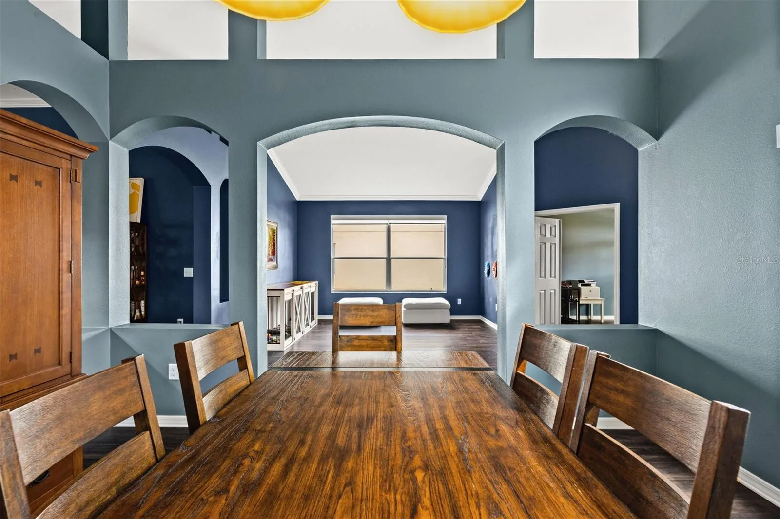 High ceilings, arched openings, and generous natural light give the main living spaces an airy, open feel.