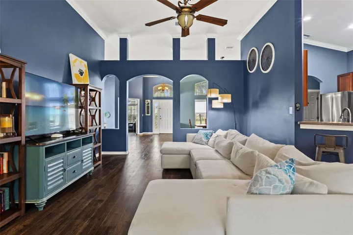 The family room’s generous proportions easily accommodate a large sectional while maintaining comfortable circulation through the room.