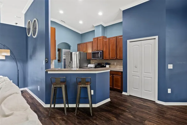 A breakfast bar adds casual seating and creates a natural transition between the kitchen and family room.