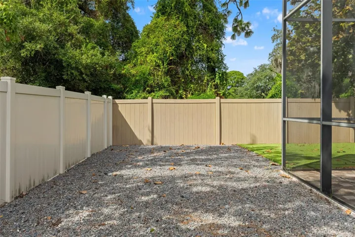 This low-maintenance side area adds another practical outdoor zone alongside the screened pool enclosure.