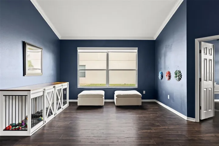 Large front windows fill this versatile living space with natural light while the open layout keeps the home feeling connected.