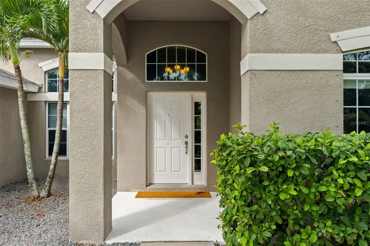 The covered front entry creates a welcoming arrival, with an arched transom bringing additional natural light inside.
