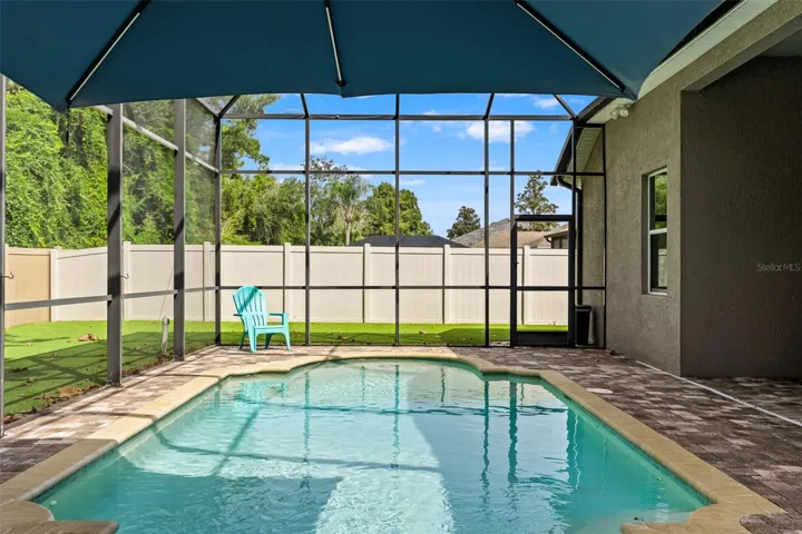 A screened saltwater pool, covered lanai, and private setting come together for the kind of backyard Florida living is all about.