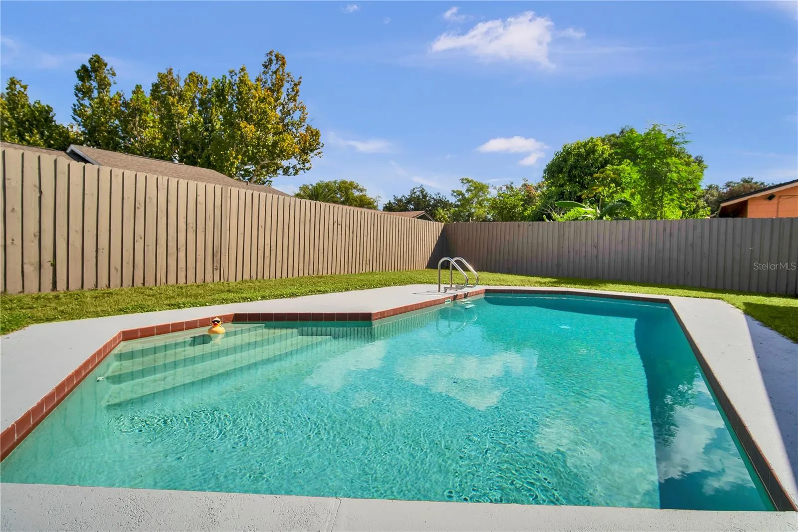 Enjoy Florida living with a fenced backyard and in-ground pool