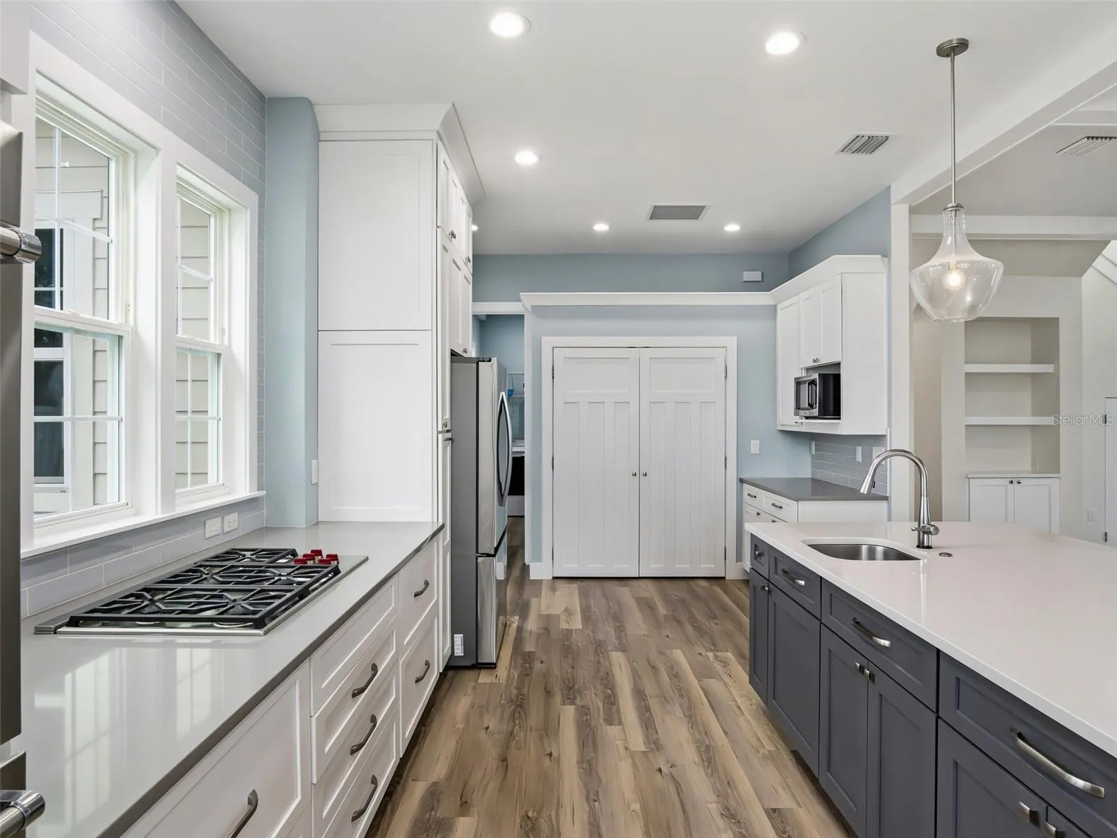 One pantry on far wall and microwave/additional space