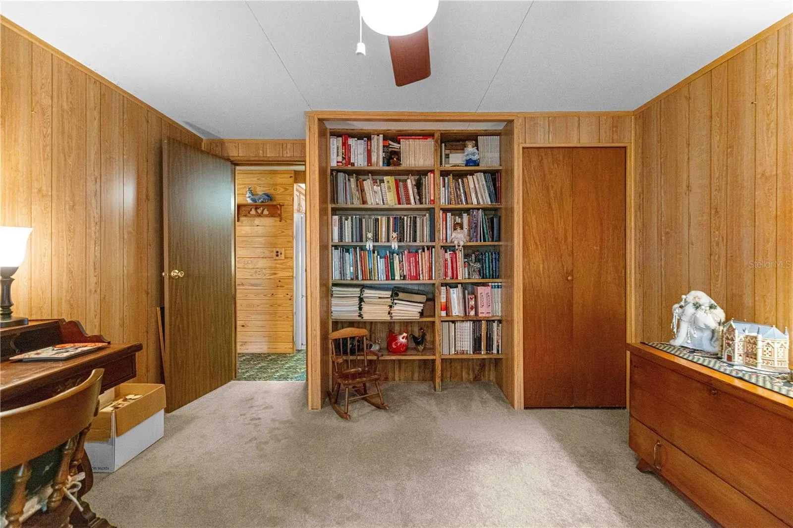 Third bedroom reverse view with built-in shelving.