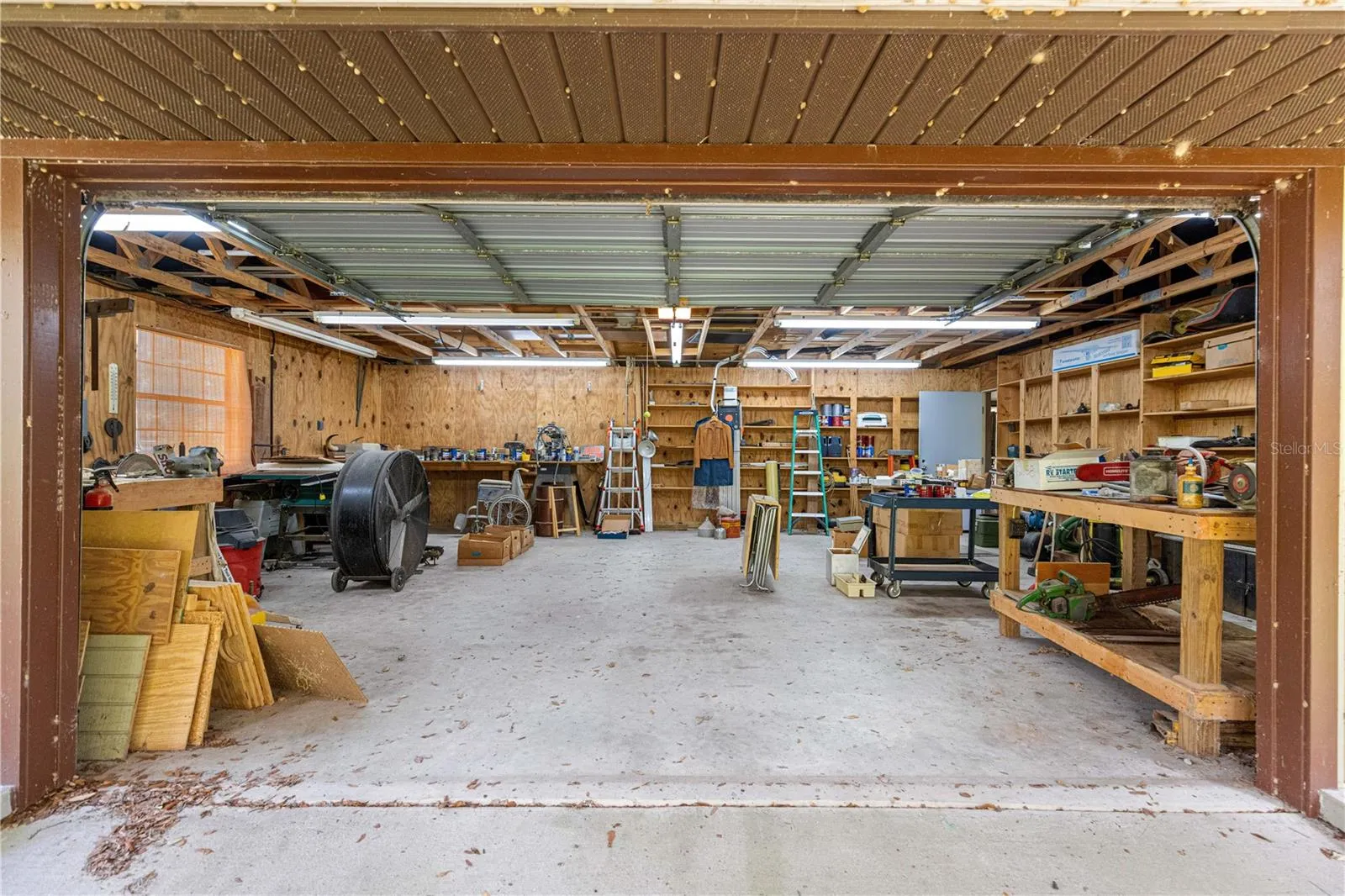Workshop interior with concrete floor and overhead door.