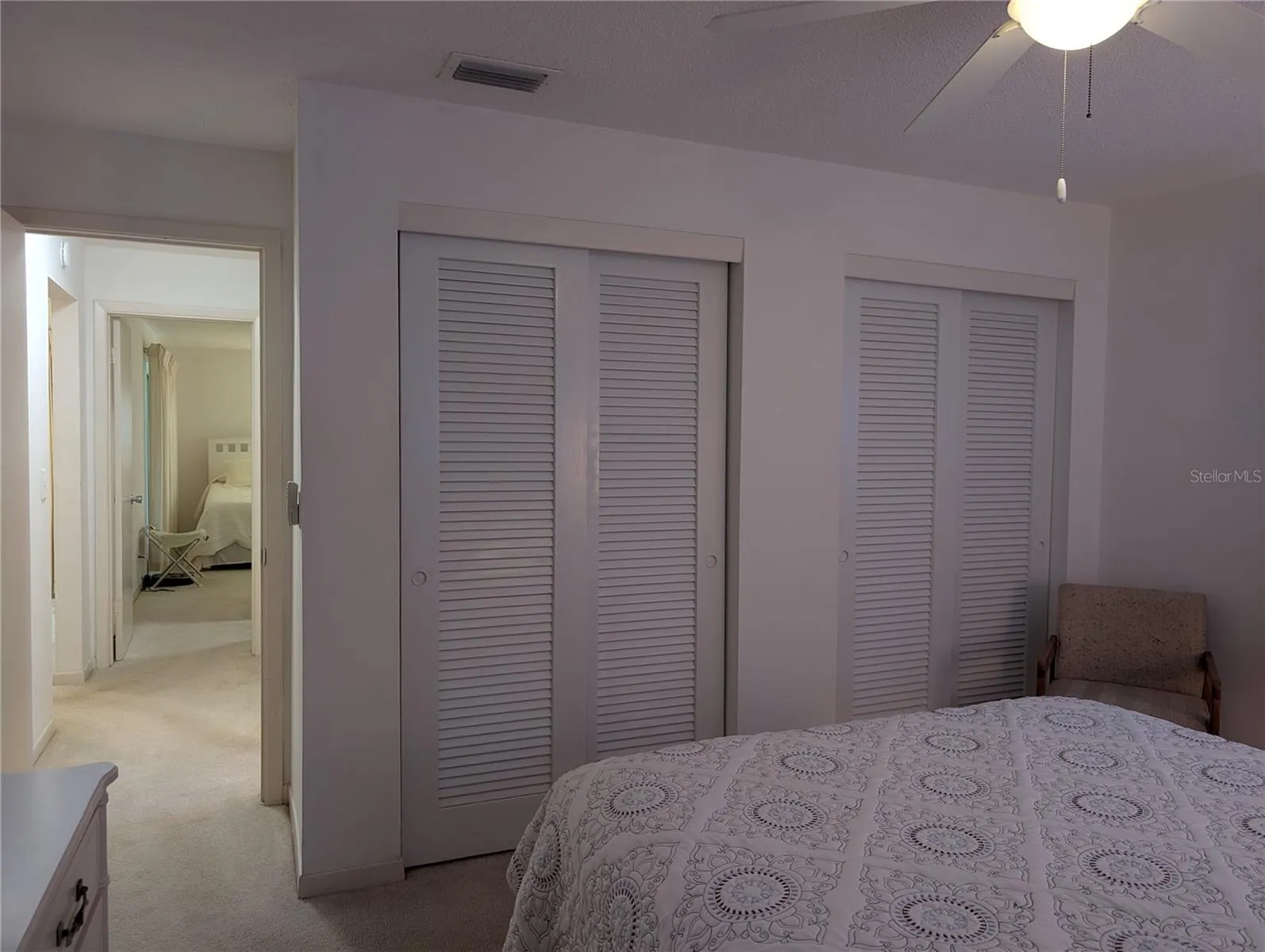 Entry into guest bedroom offering two wall closets.