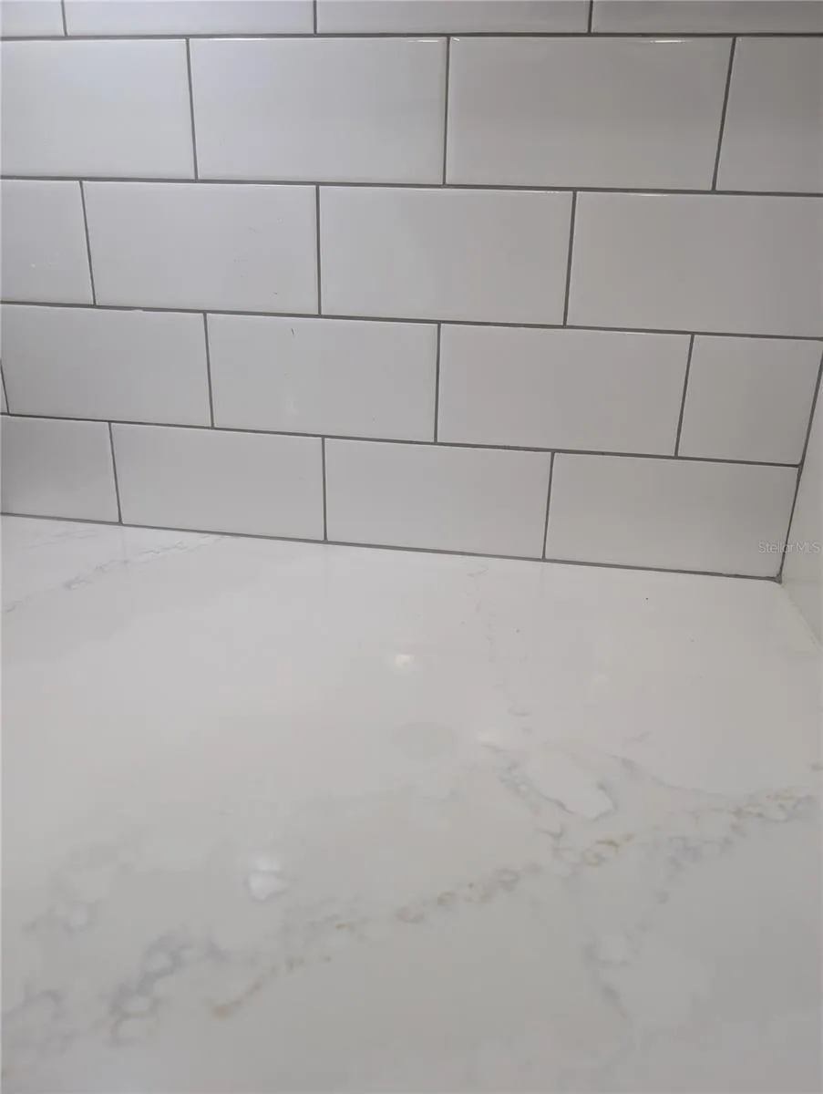 Quartz countertops with subway tile backsplash.