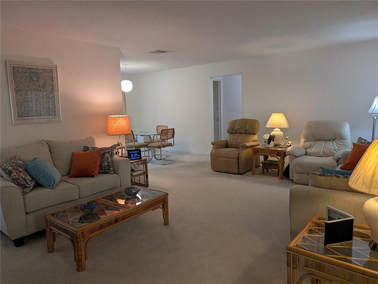 View into Hallway leading to both bedrooms and bathrooms. Primary to left, main bathroom &amp; guest bedroom to right.