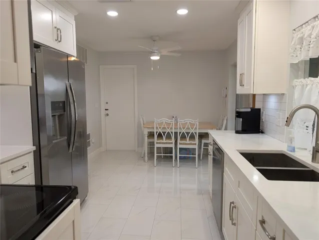 View from dining room thru kitchen to eat in area.  Kitchen door leading to garage and laundry area.