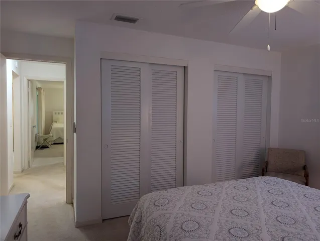 Entry into guest bedroom offering two wall closets.