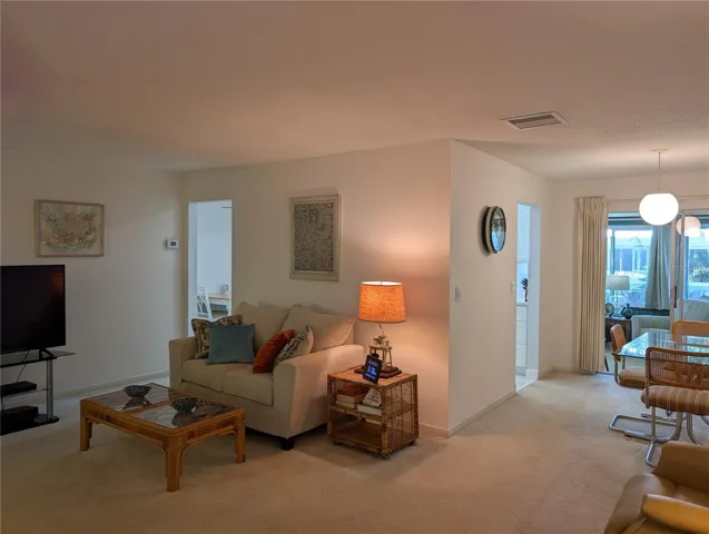Living room view of both kitchen entries. Florida room access from dining room.