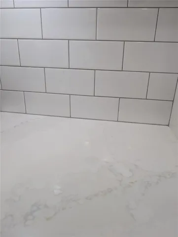 Quartz countertops with subway tile backsplash.