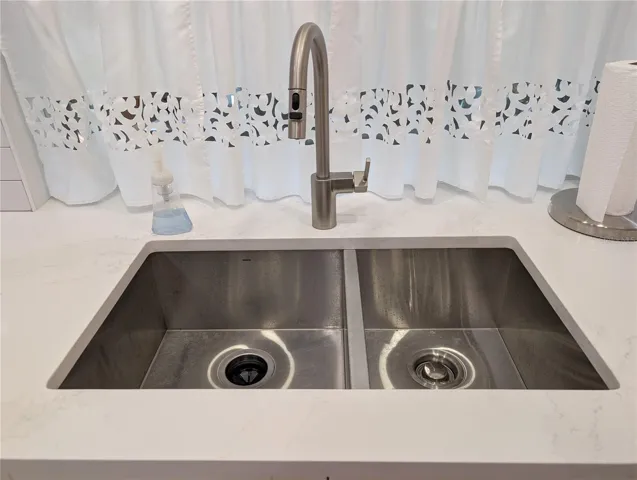 Double sided, undermount, stainless steel sink &amp; tall kitchen faucet w/pulldown sprayer.