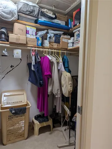 Primary bedroom walk in closet.