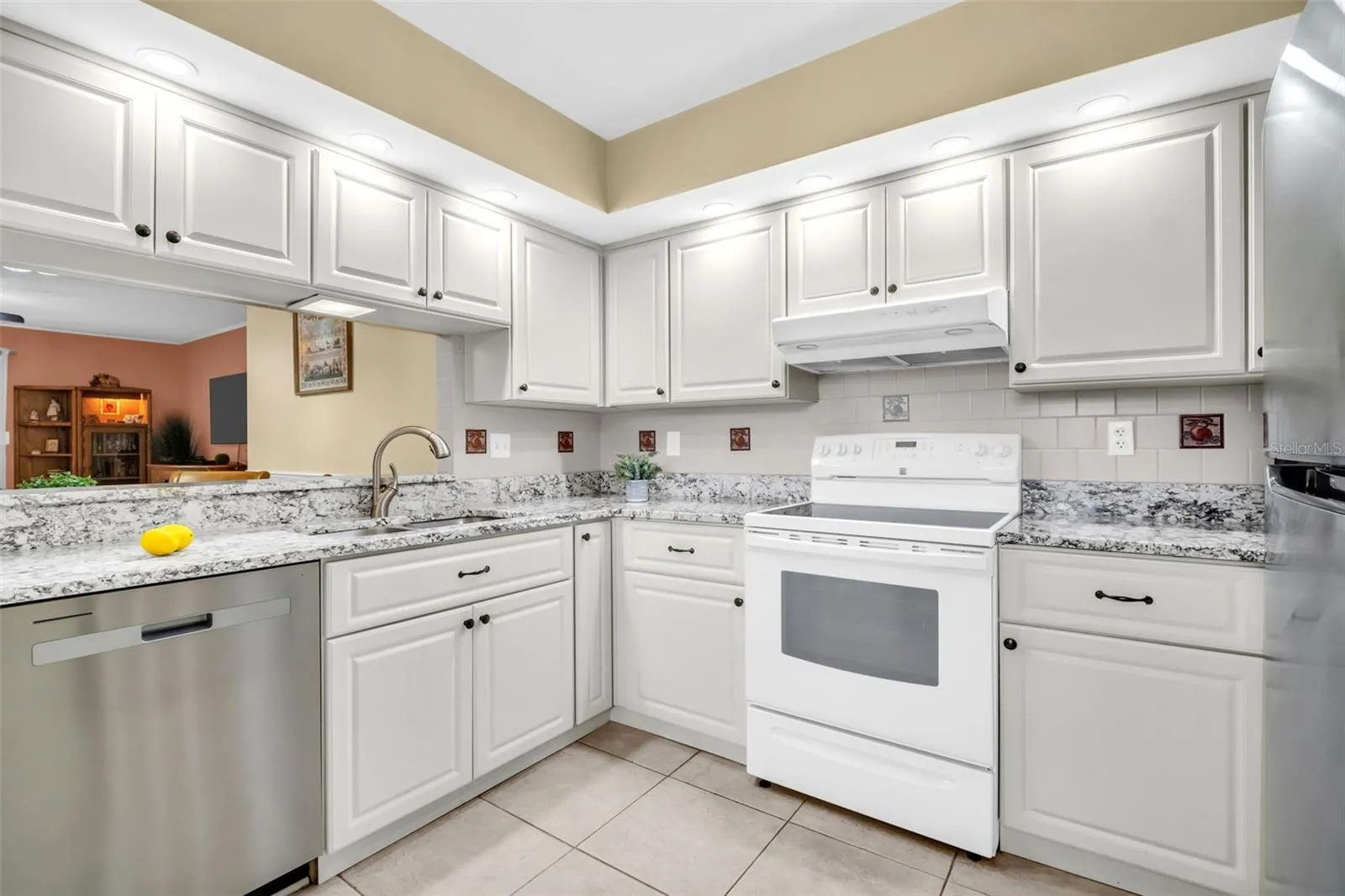 Granite countertops, solid-wood cabinetry, and recessed lighting~
