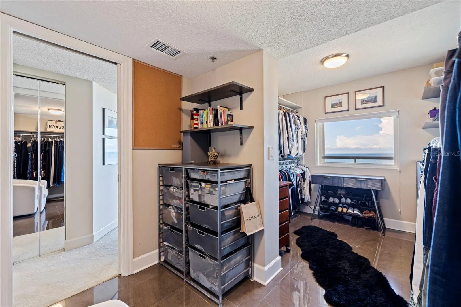 Custom designed primary walk-in closet  with view of the Gulf