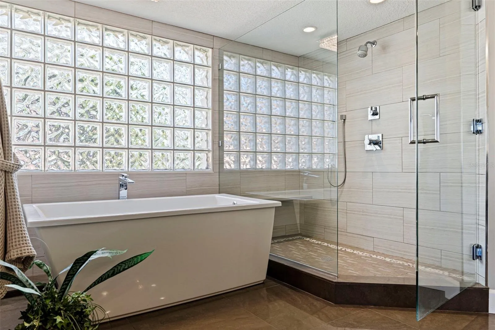 Primary en-suite with soaking tub and glass enclosed shower