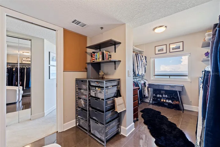 Custom designed primary walk-in closet  with view of the Gulf