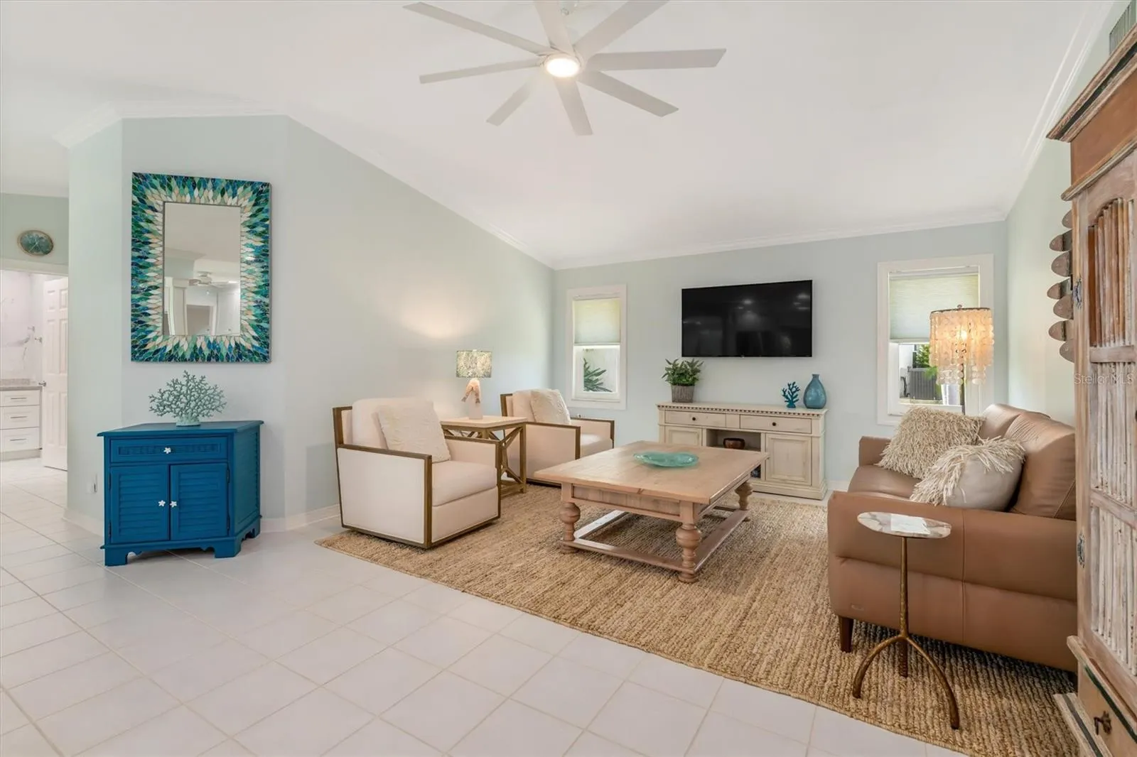 Family room has tall ceiling and is open to kitchen.