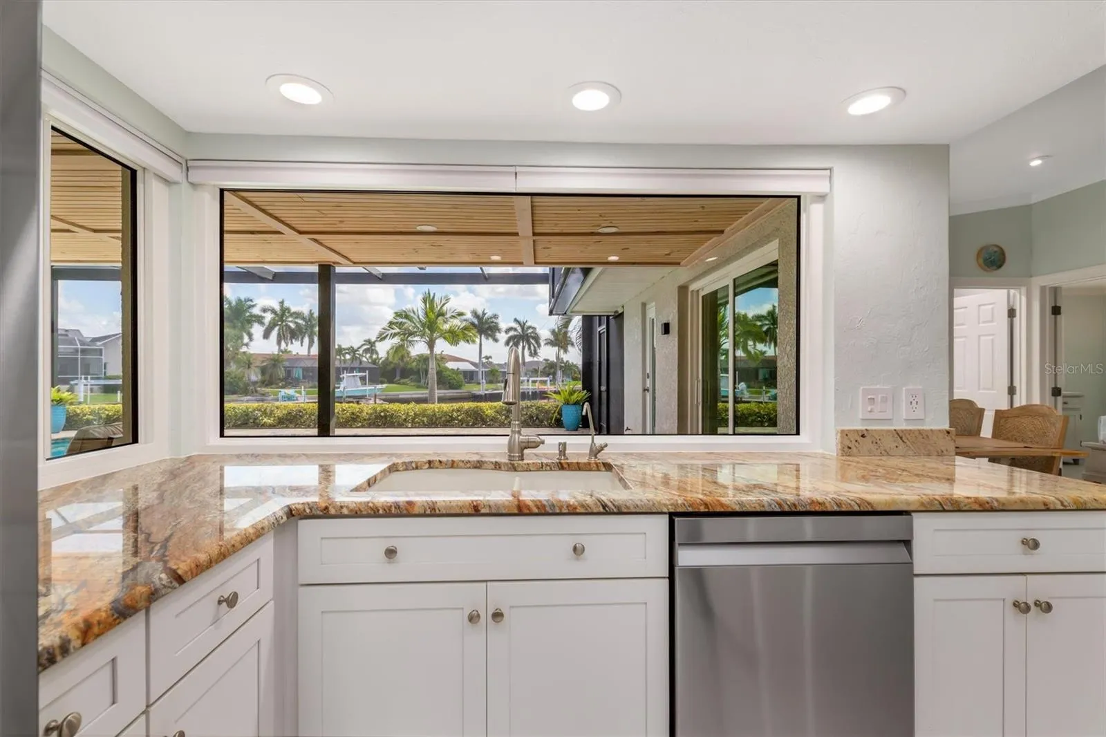 So light and bright with white cabinets and large windows.