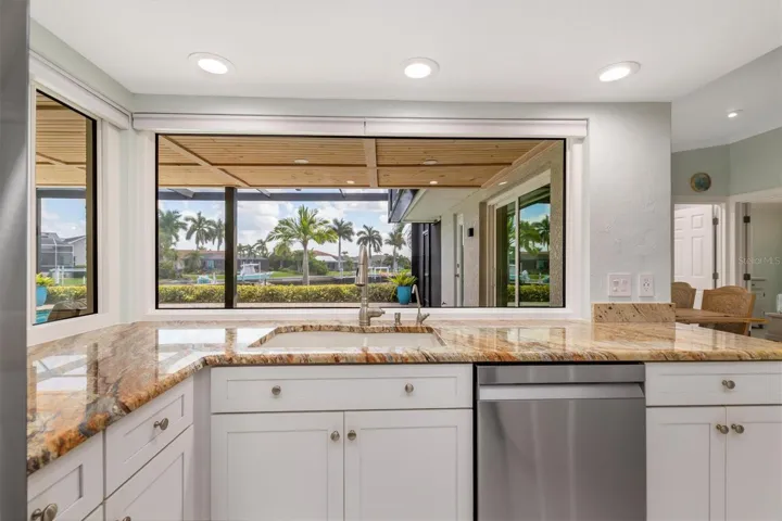 So light and bright with white cabinets and large windows.
