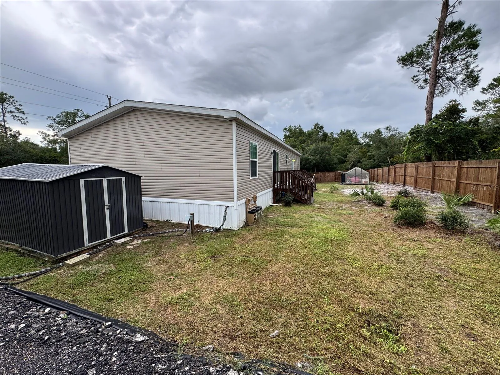 Large double door storage shed and private back yard.