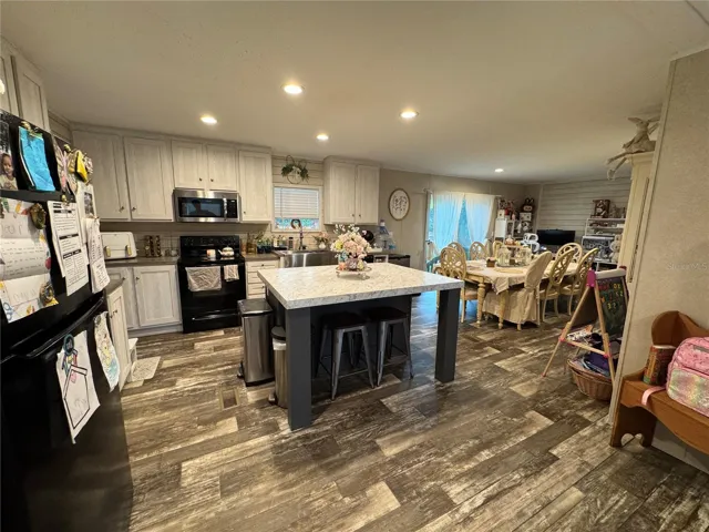Wonderful kitchen area with center island and overhang countertop