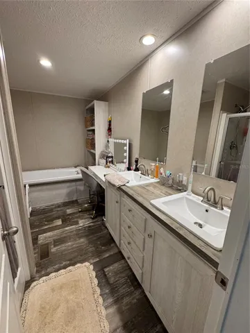 Master bath with double sinks and separate bath tub and shower