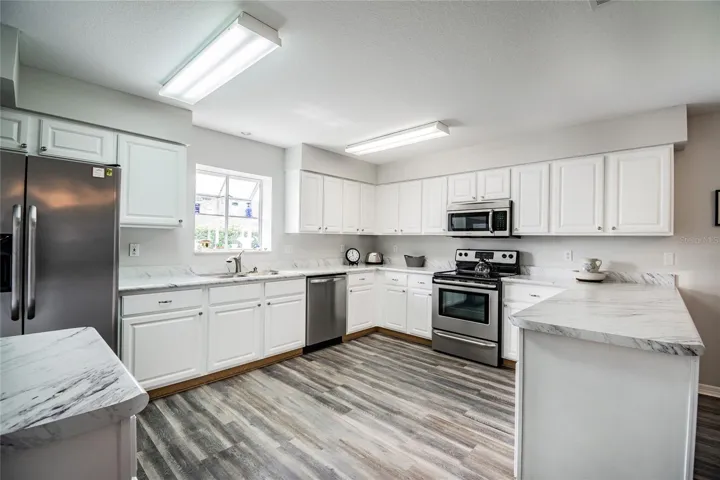 Newer laminate floors in kitchen and dining areas