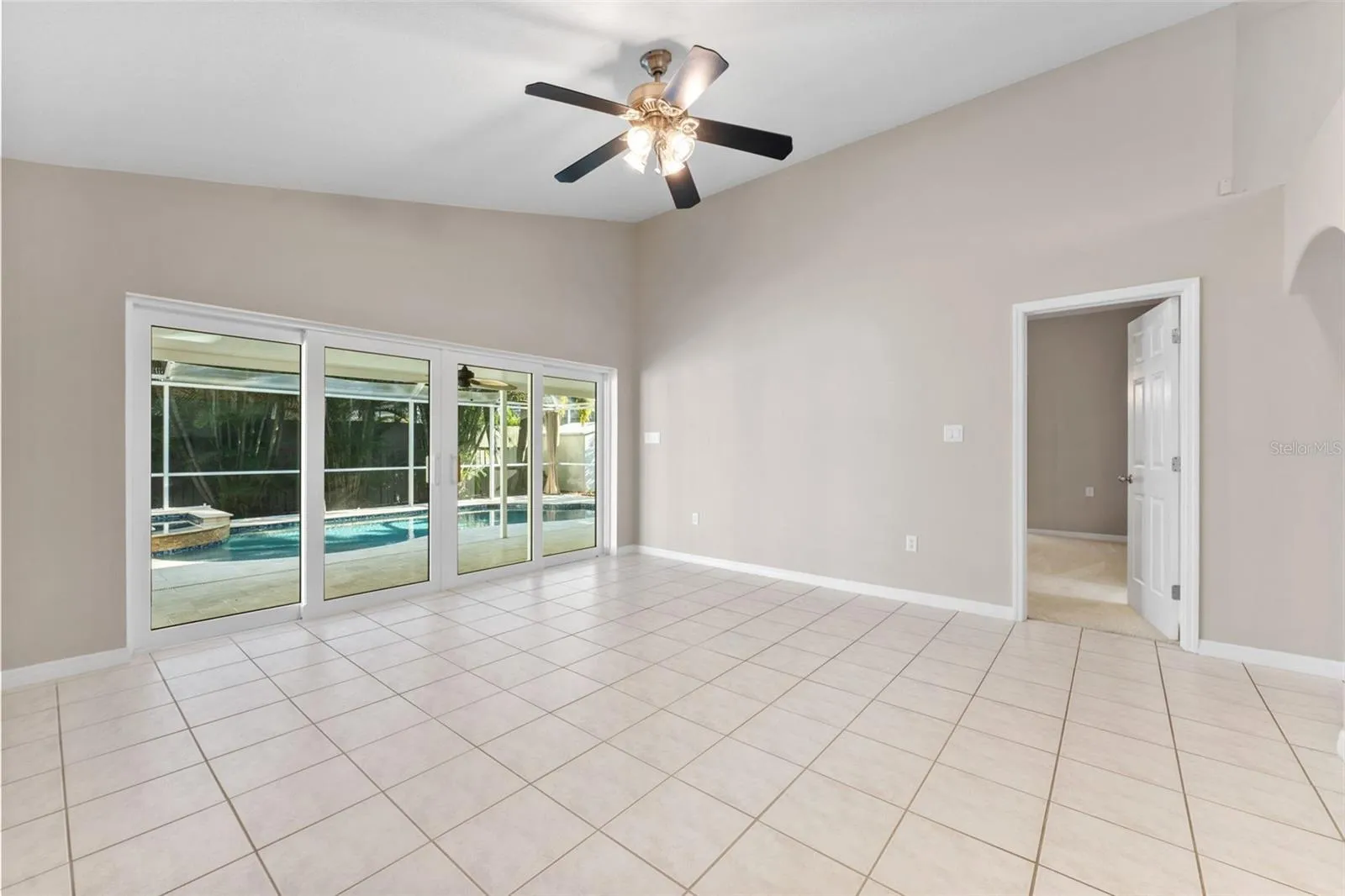 family room with entrance into primary  bedroom
