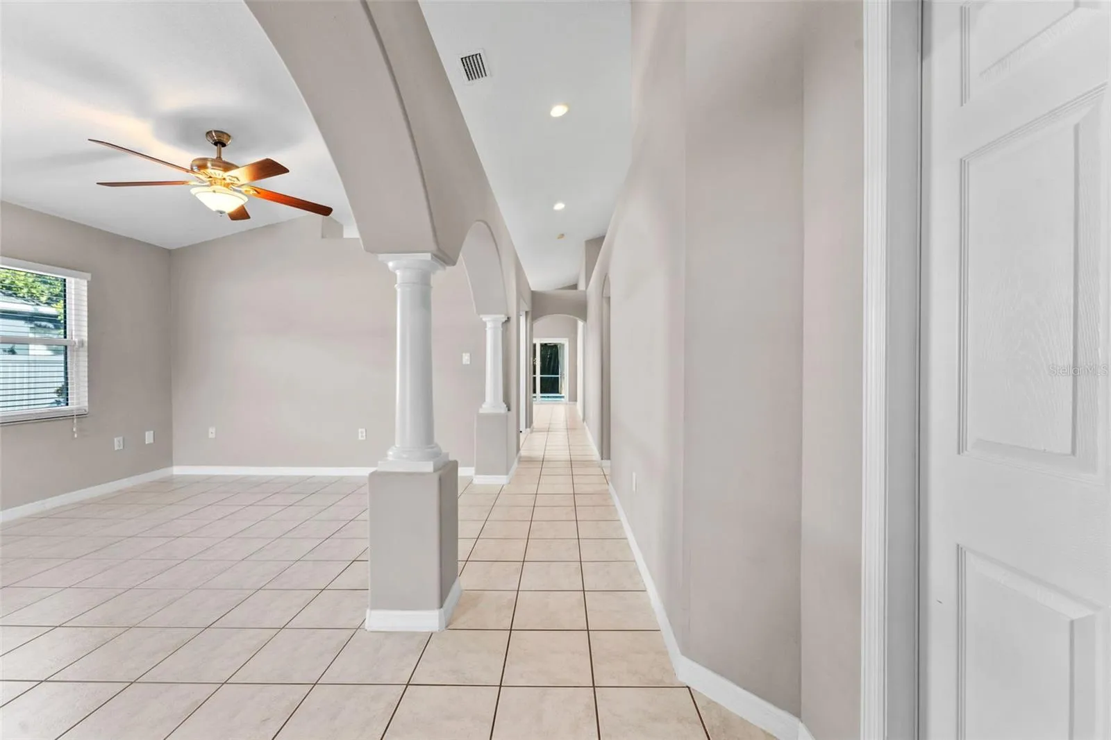 stepping through front door into hallway and dining room/living room combo
